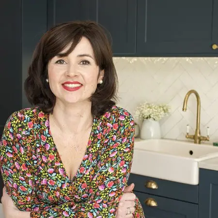 Lisa sits in her upgraded IKEA METOD kitchen in London displaying her bespoke custom made shaker doors